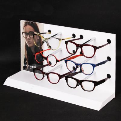 China Eco - Friendly Worktop White Acrylic Glasses Display Plexiglass Glasses Holder Rack With Insert Tiers And Poster for sale