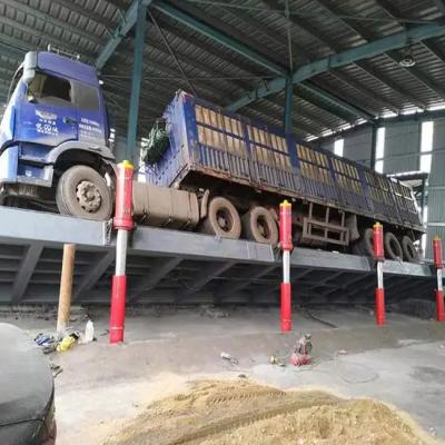 China Descargador de camión hidráulico cerrado con voltereta lateral y hacia atrás para manejo eficiente de carga en venta