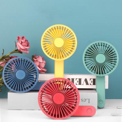 China New Style High Efficiency Cartoon Mini Charging Fan Portable Solid Color Handheld Rechargeable Fan for sale