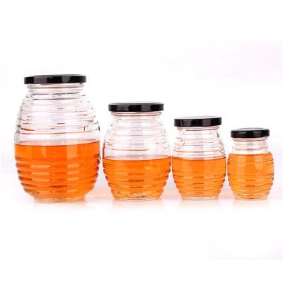 China 70ml 180ml 380ml 730ml cheap honey jam glass jars bulk canned food with black metal lid for sale