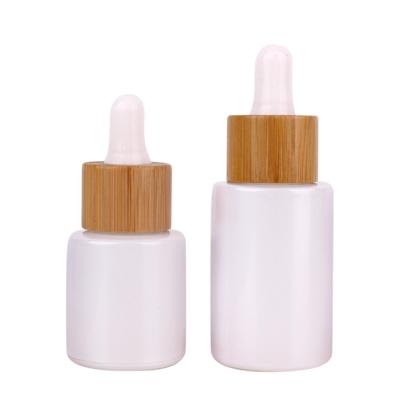 China Personal Care 2oz Painted Glass Dropper Bottle Essential Oil Bottle With Wooden Lid for sale