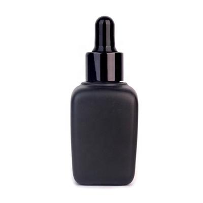 China Refillable 1oz Cosmetic Packaging Rose Oil Essential Oil Packaging Black Glass Bottle With Dropper for sale