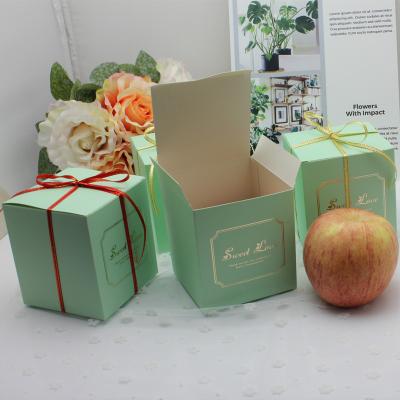 China Recycled Materials Christmas Eve Apple Box With Gold Stamping Paper Gift Box With Gold Border Ribbon for sale