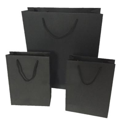 China Luxury Black Recycled Materials Paper Bag Boutique Gift Recyclable Shopping Bag For Shoes And Garment for sale