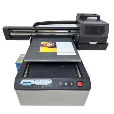 China Hotels Factory cost 6090 flatbed UV printer printing phone case /Pen/Ceramic/Metalic/Acrylic/Glass/Boltte/Golf ball etc for sale