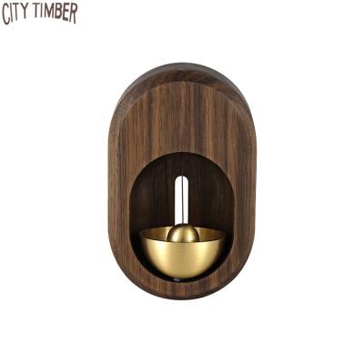 China Rustic New Design Wooden Creative Magnetic Suction Wind Rings Door Bell Decorative Hot Sale Wholesale Hanging Brass Bell for sale