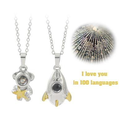 China Cute Rocket Pendant Necklace 100 Couples Jewelry Astronaut Tongues Projection Necklace I Love You For Lover for sale