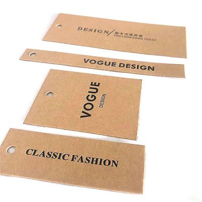 China Sustainable Shape Custom Tag Black Gold Kraft Paper Tag For Clothing for sale