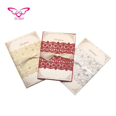 China Artificial Laser Cut and Embossing Flower Belly Band Invitation Card Gold Ribbon Bow Wedding Invitations for sale