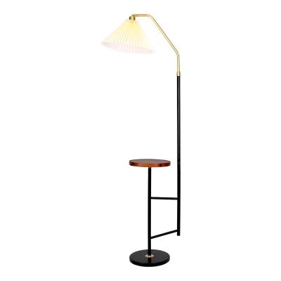 China Nordic style hot sale wrought iron wrought iron with shelf black high quality custom made bedroom floor lamp for sale