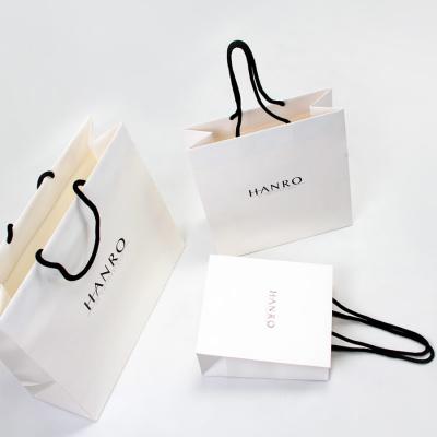 China Handmade Classic Garment Shopping Paper Bags Made Of Premium White Paper Card for sale