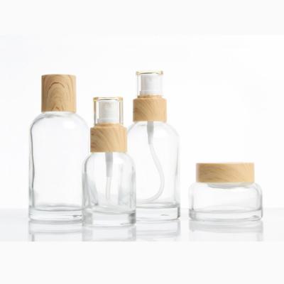 China Low MOQ Cosmetic Transparent Glass Bottles With Inner Cork For Essential Water for sale