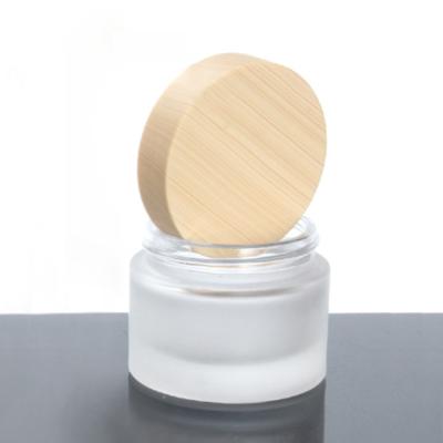 China Eco-friendly LOW MOQ 10g Recyclable Empty Skin Care Use Frosted Glass Cream Jars With Wooden Lid for sale