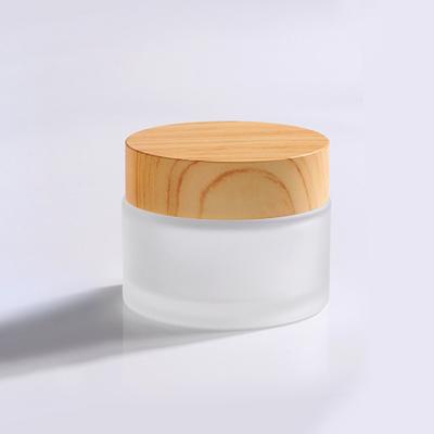 China LOW MOQ Guangzhou Factory 15g Eco-friendly Recyclable Empty Frosted Bamboo Cap Cream Use Glass Cosmetic Jar for sale