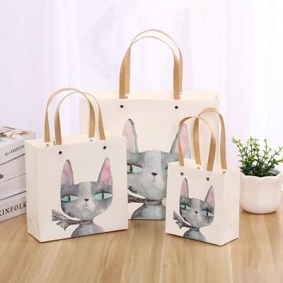 China Recyclable Cute Paper Bag Tote Bag Packaging Kitty Design Birthday Gift Paper Bag With Handle Plastic Rope for sale