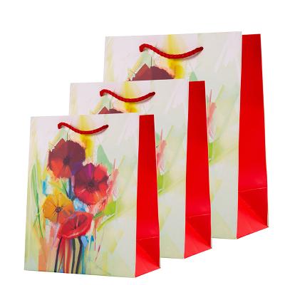 China Recyclable Custom Logo Flower Birthday Gift Paper Flower Pattern Packaging Gift Multicolor Paper Bag for sale