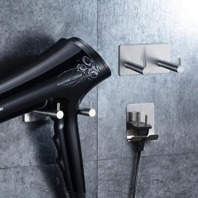 China New Design 304 Stainless Steel Hair Dryer Sustainable Adhesive Holder Bathroom Wall Mounted Hair Dryer Holder for sale