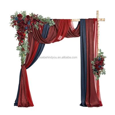 China Hanging flower arrangement backdrop in burgundy wedding backdrop decoration bridal shower with greenery and fabric curtains for sale