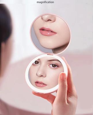 China LED Lighted Lighted Mini 3X Magnifying Compact Travel Sensing Lighting Portable Led Makeup Mirror for sale