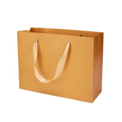 China Recyclable Wholesale Goods In Gold Matt Craft Paper Bolsas De Papel Stock Waterproof Cardboard Bag Packaging Bags for sale