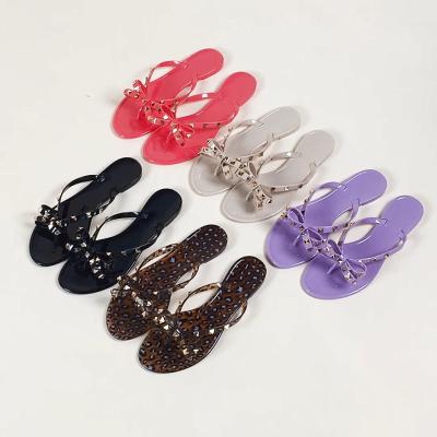 China Fashion Rivet Bow PVC Durable Wholesale Hot Selling Slippers Customized Jelly Flip Flops Women for sale