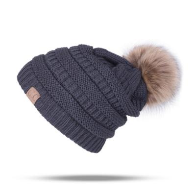 China Character winter men's and women's sleeve plus fluffy balls knitted outdoor hat keep warm hat popular style warm hat for sale