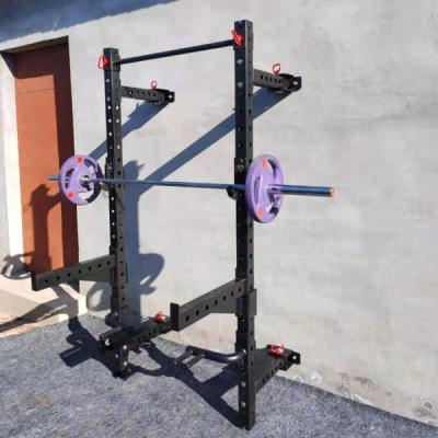 China Commercial Wall Mount Folding Equipment Gym Power Squat Rack with J-Hooks and Spotter Arms for sale