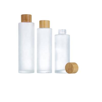 China Cosmetic Packaging China Frosted 120ml 100ml 150ml Glass Cosmetics Containers And Lotion Packaging Glass Bottles With Wooden Screw Cap for sale