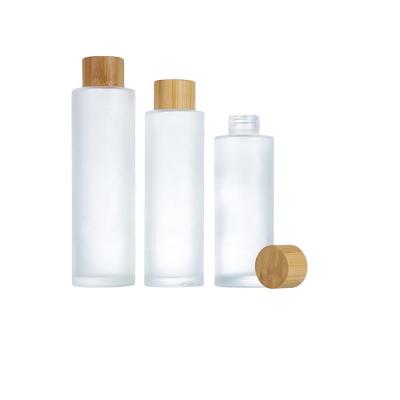 China Personal Care Fashion Design 100ml 120ml 150ml Frosted Empty Glass Clear Packaging Cosmetic Bottle With Bamboo Screw Cap for sale