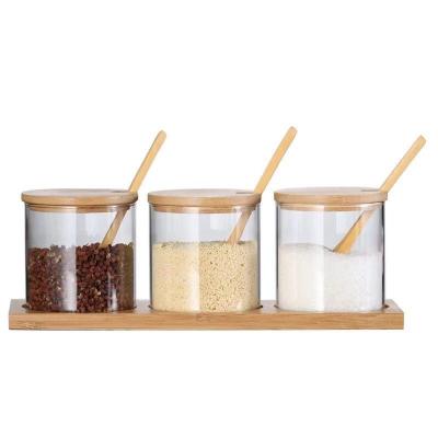 China Transparent Glass Storage Stocked Spice Jar With Bamboo Clamp Lid for sale