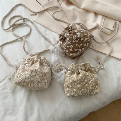 China Fashion Summer Beach Bag Small Rattan Flower Woven Drawstring Straw Bag for sale