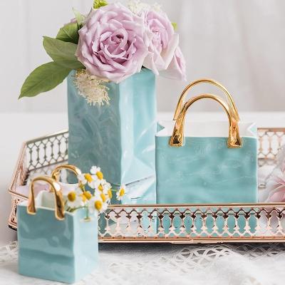 China Nordic Creative Ceramic Handbag High Quality Ceramic Handbag Inspired Small Mini Flower Bag Vase For Living Room Luxurious Handle for sale