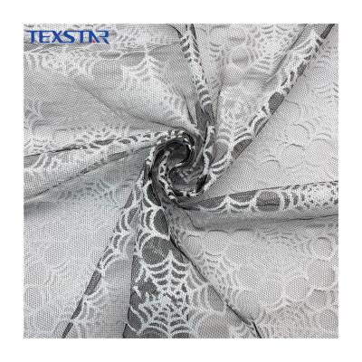 China Shrink-Resistant Glow in Dark White American Tulle Mesh Fabric with White Spider Web for Halloween Decoration for sale