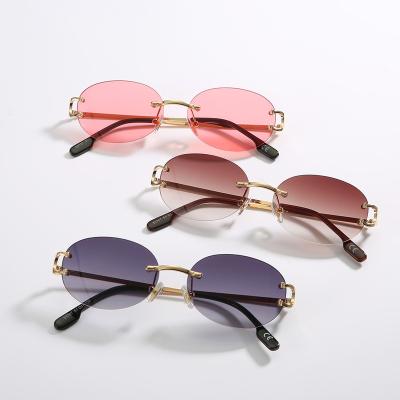 China 2022 fashion sunglasses men and women's pointed oval rimless sunglasses retro small sun glasses uv400 for wholesales 50707 for sale