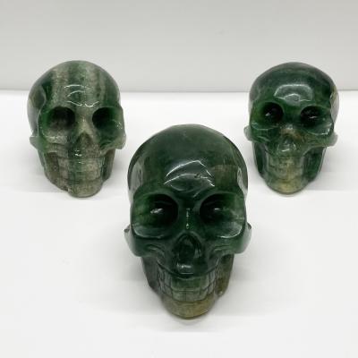 China Hot Sale China High Quality Natural Quartz Crystal Skulls Green Strawberry Crystal Human Head Bone For Fengshui for sale