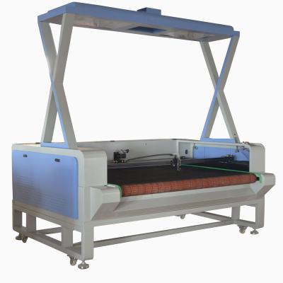 China High Productivity 100w/130w/150w Water Cooled Auto Feeding Laser Cutting Machice For Fabric With 1810 1800*1000 Projector for sale