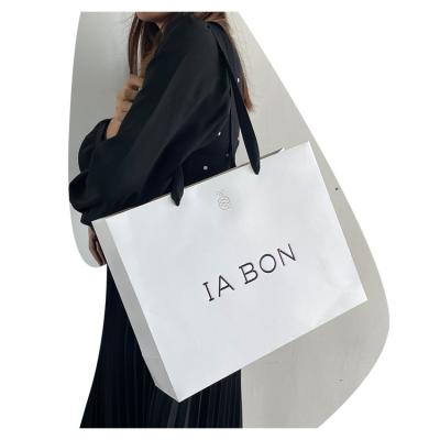 China Recyclable luxury custom white logo apparel boutique china gift shopping paper bags with handles for sale