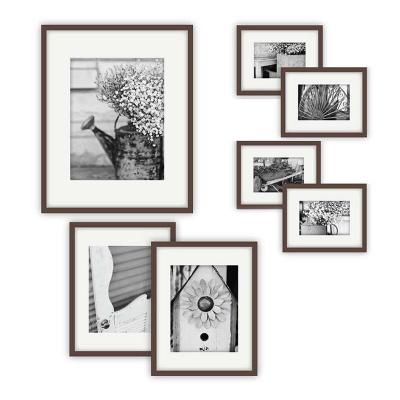 China Perfect Eco-Friendly 7 Piece Walnut Picture Frame Gallery Wall Kit with Decorative Art Prints and Hanging Template for sale