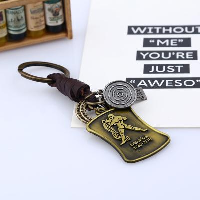 China Promotion Gift Hot Selling Retro Guitar Shaped Cowhide Metal Key Ring Zodiac Keychains For Birthday Woven Key Chain Handmade Gifts for sale