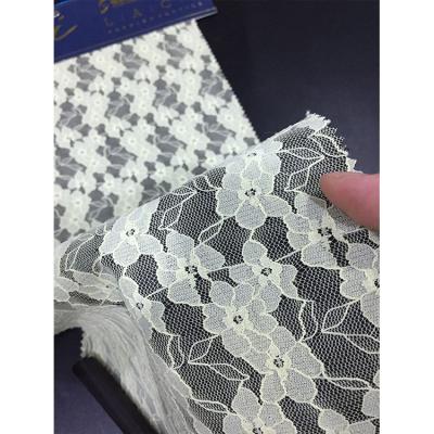 China 2019 Sustainable Stretch White Flower And Black Compound Rope Lace Fabric for sale