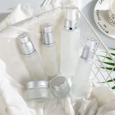 China 50ml Cosmetic 60ml Customized Round Glass Bottle Sets Empty Glass Cream Jar And Pump Spray Bottle Set Skin Care Face Cream Lotion Bottle for sale