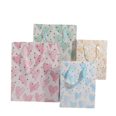 China Disposable Heart Shape Gift Paper Bag Wrap Silk Handle Gold Foiled White Card Paper for sale