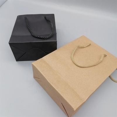 China Recycled Materials Custom Your Own Logo Craft Black Brown Paper Bag For Apparel Shows T-Shirt for sale