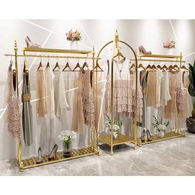 China Modern Elegant Gold Silver Stainless Steel Clothing Retail Display Rack For Clothing Stores for sale