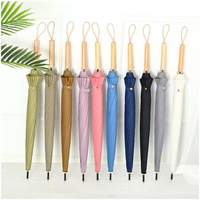 China Modern Personalized hot selling steel frame windproof wooden handle 16 bone long handle straight rod travel outdoor umbrella for sale