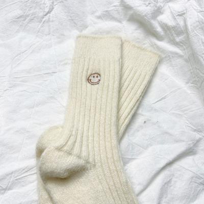 China Women Solid Color Embroidery QUICK DRY High Quality Logo Custom Design Winter Wool Warm Crew Smiling Face Tube Socks for sale