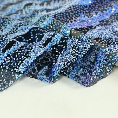 China Mermaid Shrink-Resistant Sequin Embroidered Fabric 130cm Super Dense Water Wave Blue Sequin Stage Dress Fabric for sale