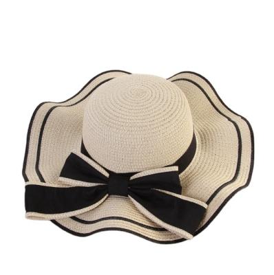 China Character factory direct sale summer large wavy bow straw hat ladies beach fashion sunscreen hat for sale