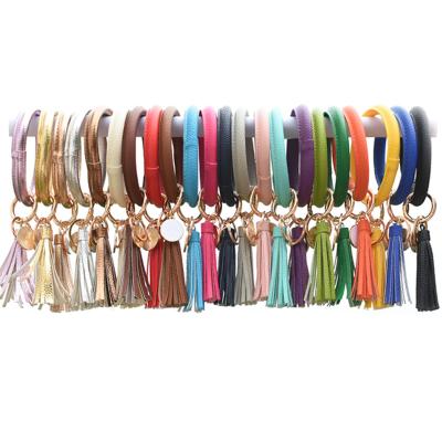 China New Eco-Friendly Fashion Big Round Key Chain Bracelet Leather Tassel Key Chain Wristband Bracelet For Women Girls for sale