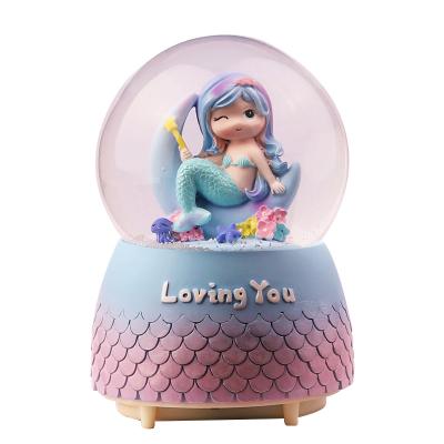 China 2023 Folk Art Mermaid Crystal Ball Resin Ornaments With Music Drift Snow Hotel Decoration Light And Family Souvenirs Gift for sale